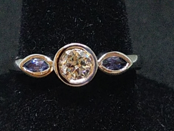 Center Bezel Round Diamond with blue Marquise sapphire bezels on sides