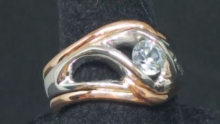 Rose gold outer bands with freeform whte gold center with a clear MT Sapphire 3